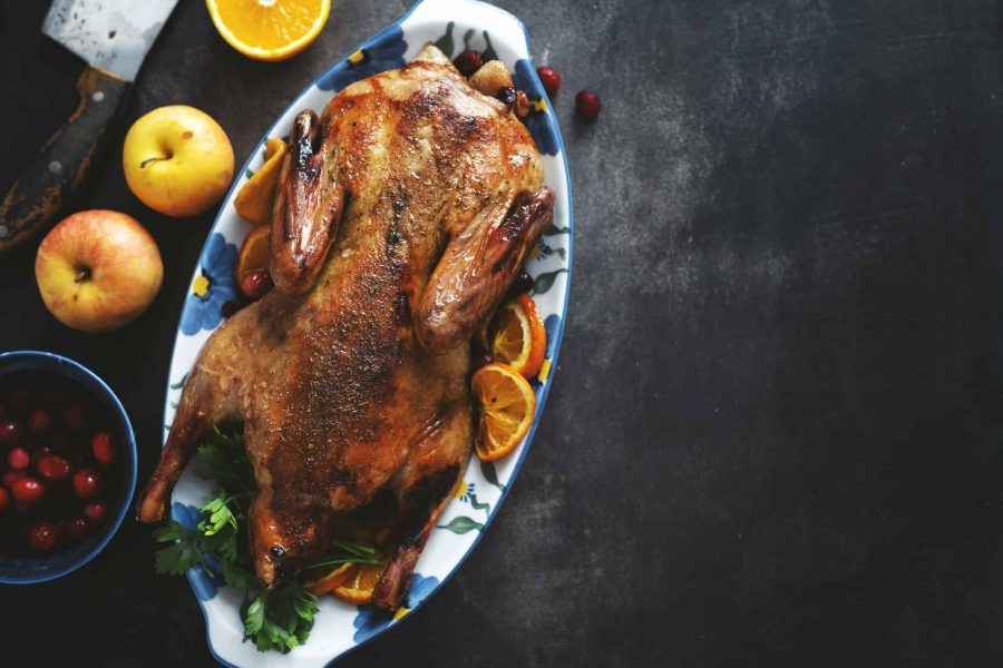 Baked duck with vegetables served on table. Top View.